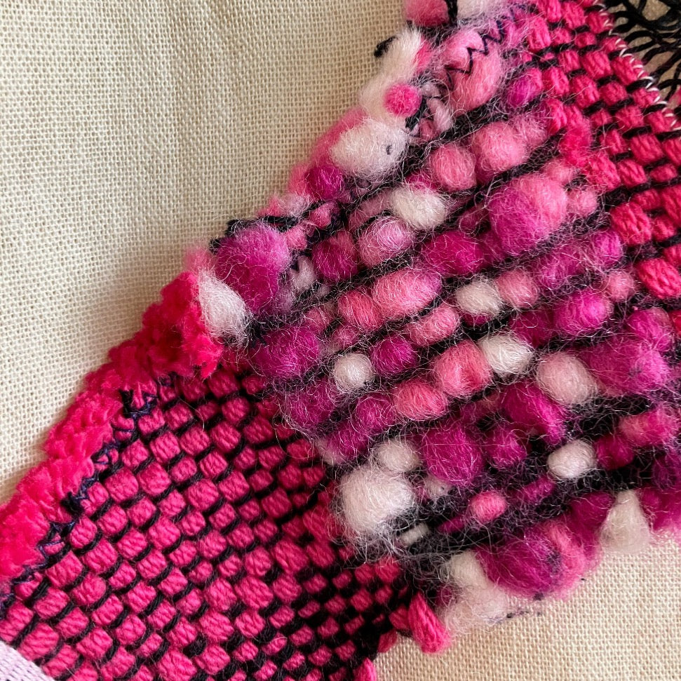 Close up of pink wool and cotton on beige bag