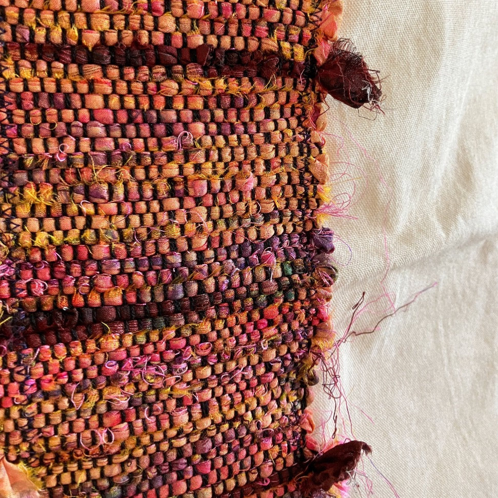 Close up of multi color silk on beige bag