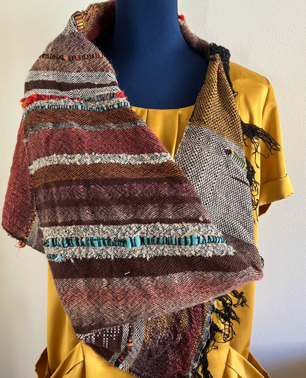 Brown toned shawl scarf around mannequin dressed in gold dress