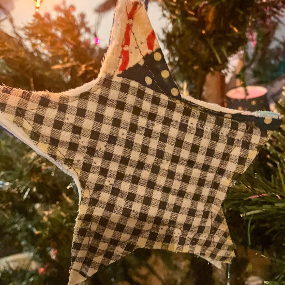 Quilted star hanging on Christmas tree with Christmas lights