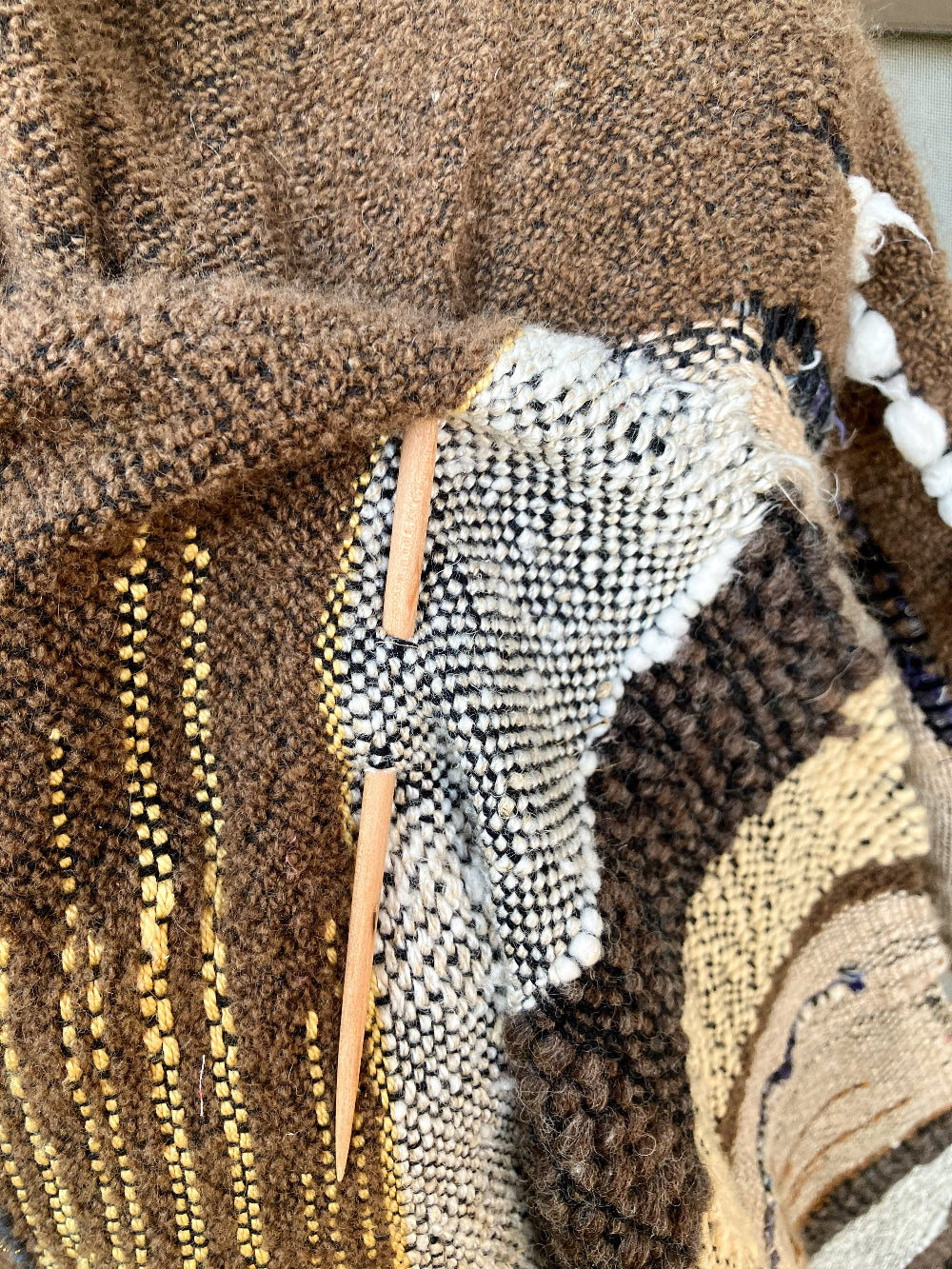 brown woolen shawl and wooden pin