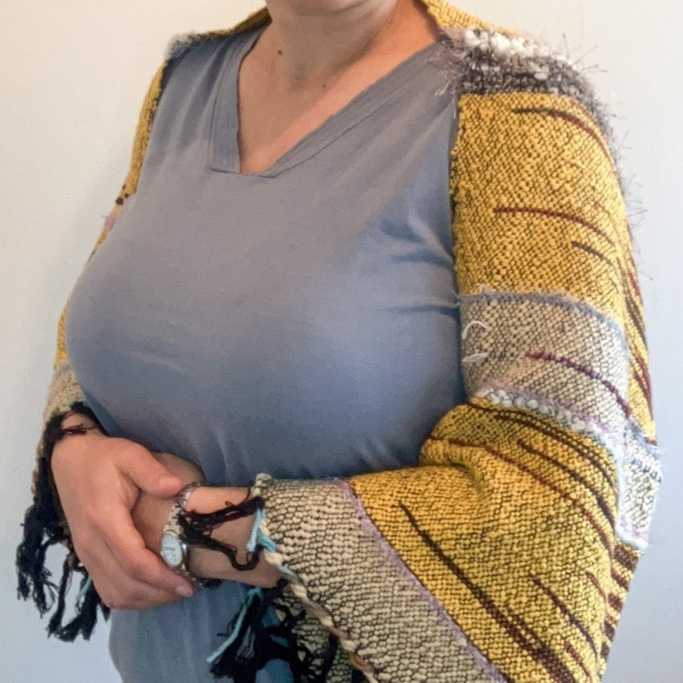 Female model wearing brown and yellow shrug
