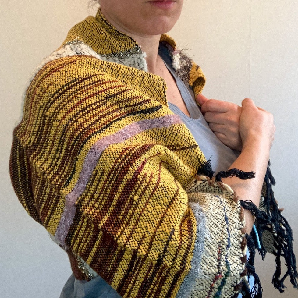 Female model wearing brown and yellow shrug