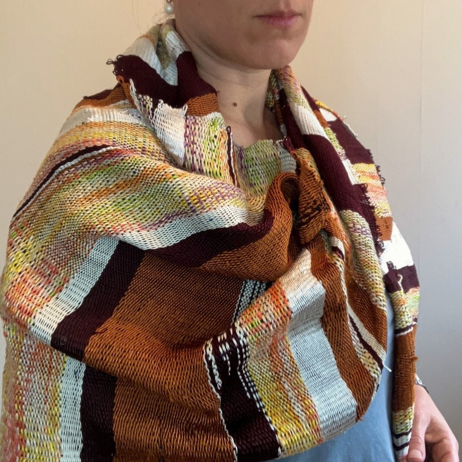 Female model wearing brown and cream silk shawl draped over shoulders