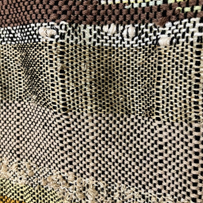 Upclose detail of brown and tan textured yarn of panel