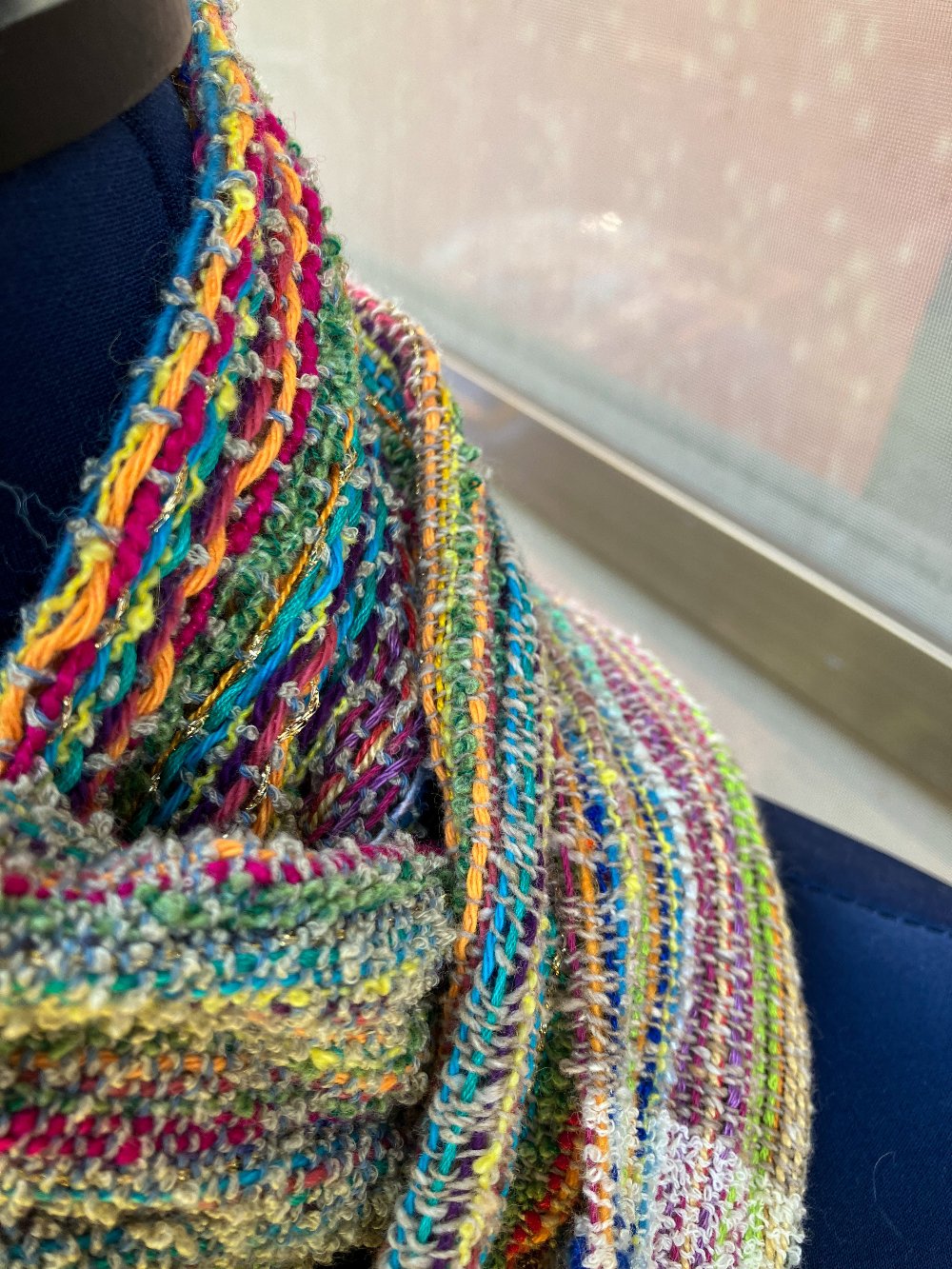 Various textures and colors of scarf closeup