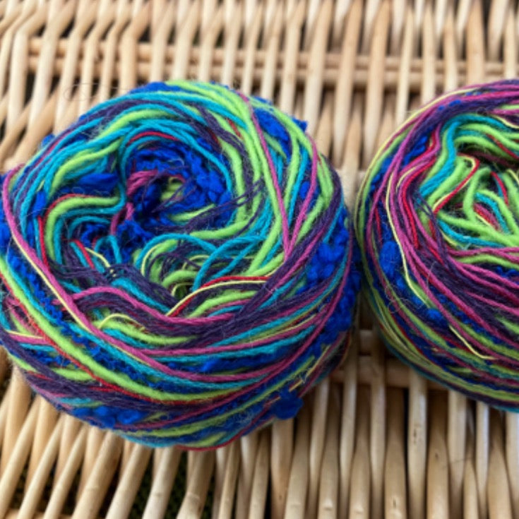 two balls of blue+pink+purple+green mixed fiber yarn