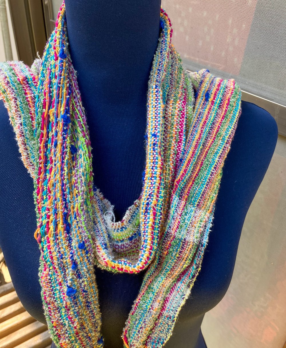 Neatly draped scarf over mannequin