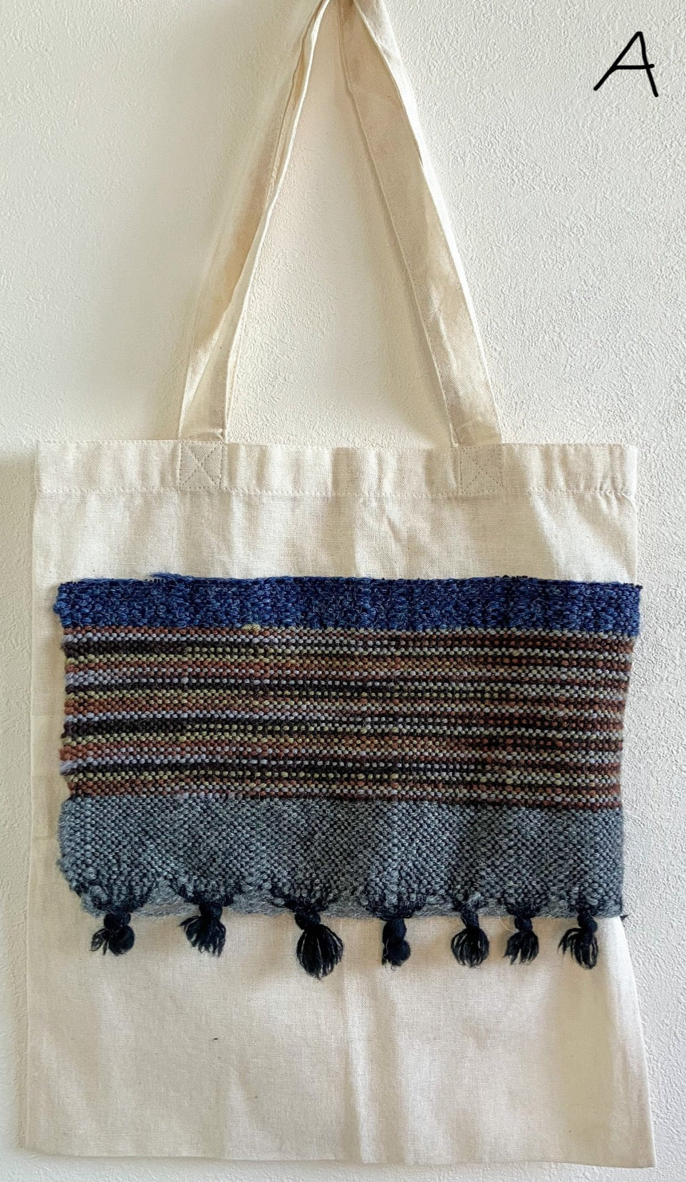 Beige cotton bag embellished with wide strip of blue and grey wool