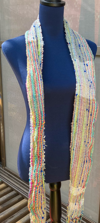 Colorful scarf draped over blue mannequin