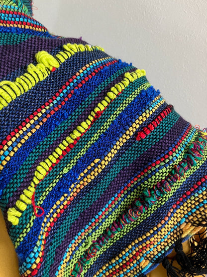 Detail of neon colored yarn on the back of the shawl scarf