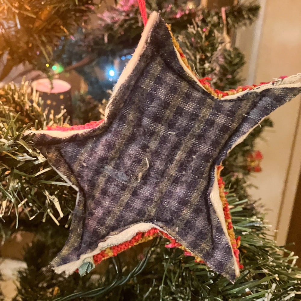 Quilted star hanging on Christmas tree with Christmas lights