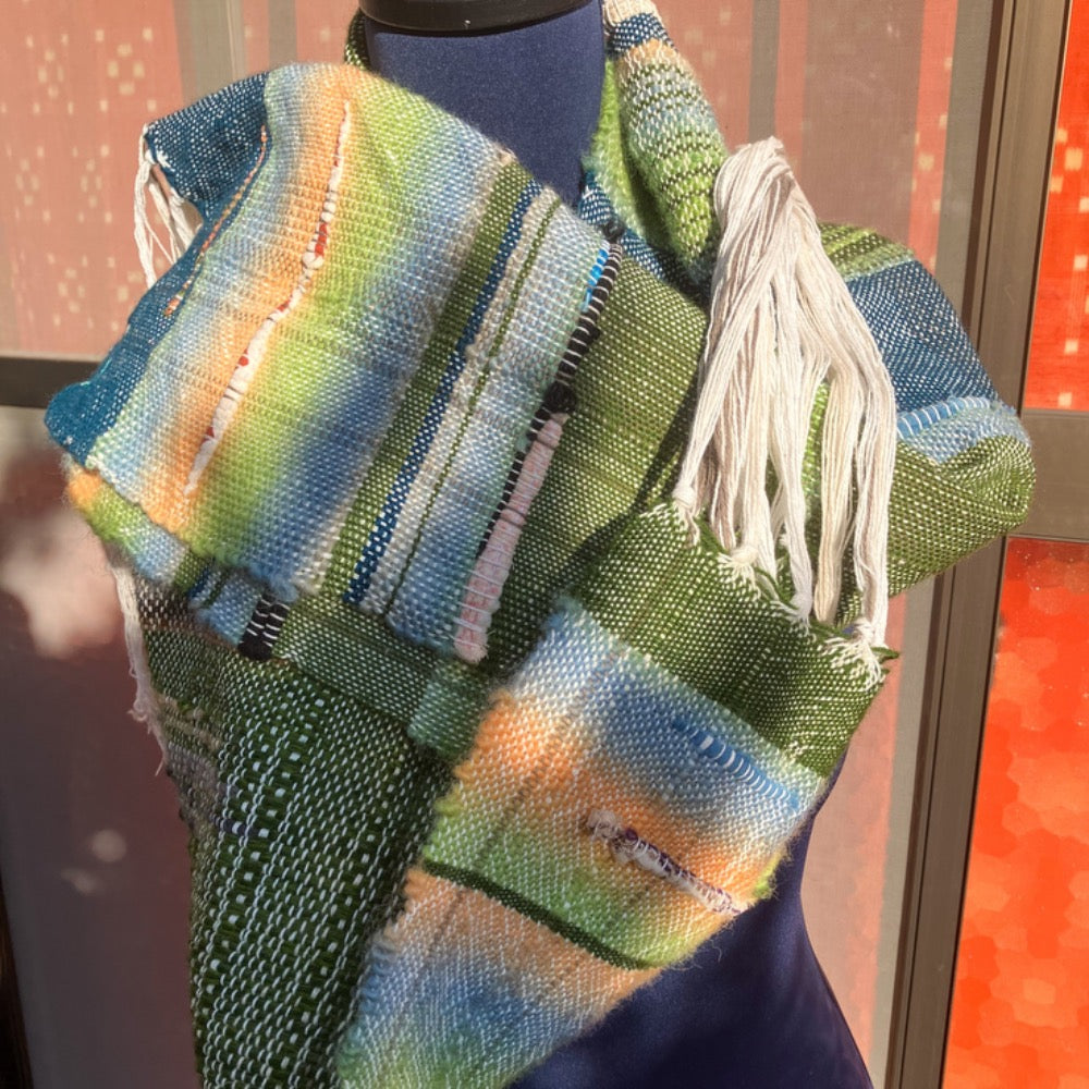 Green and blue scarf on blue mannequin