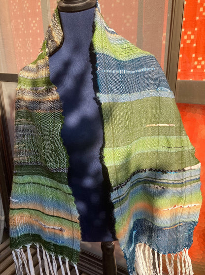 Green and blue scarf on blue mannequin