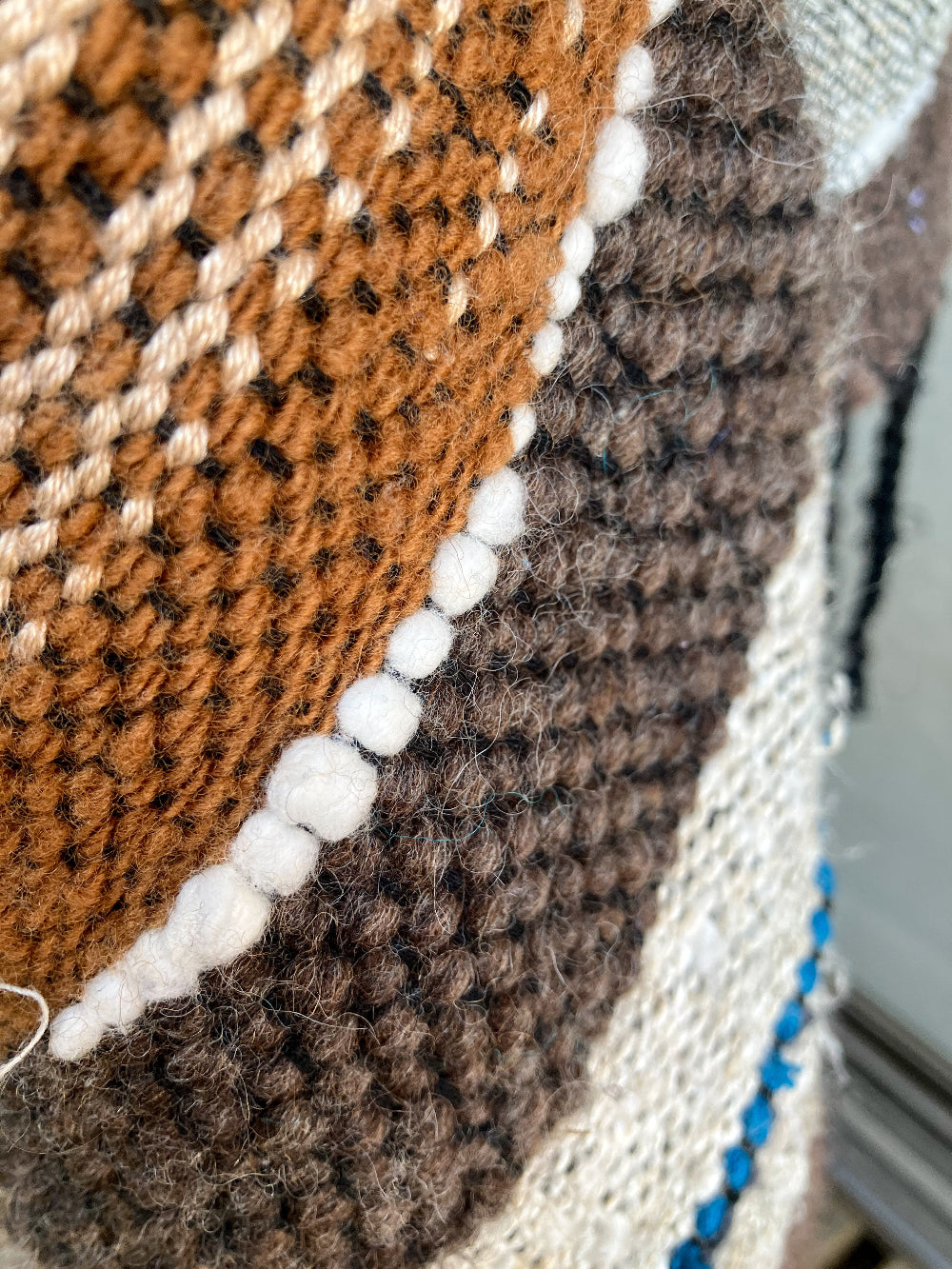 detail of white cotton and brown wool