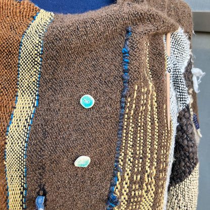 Up close of brown winter shawl and blue ceramic buttons