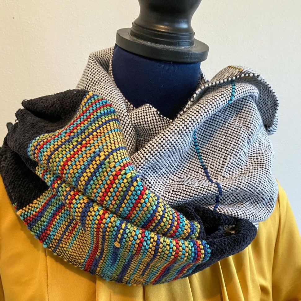 Multicolor and black and white scarf wrapped around a mannequin