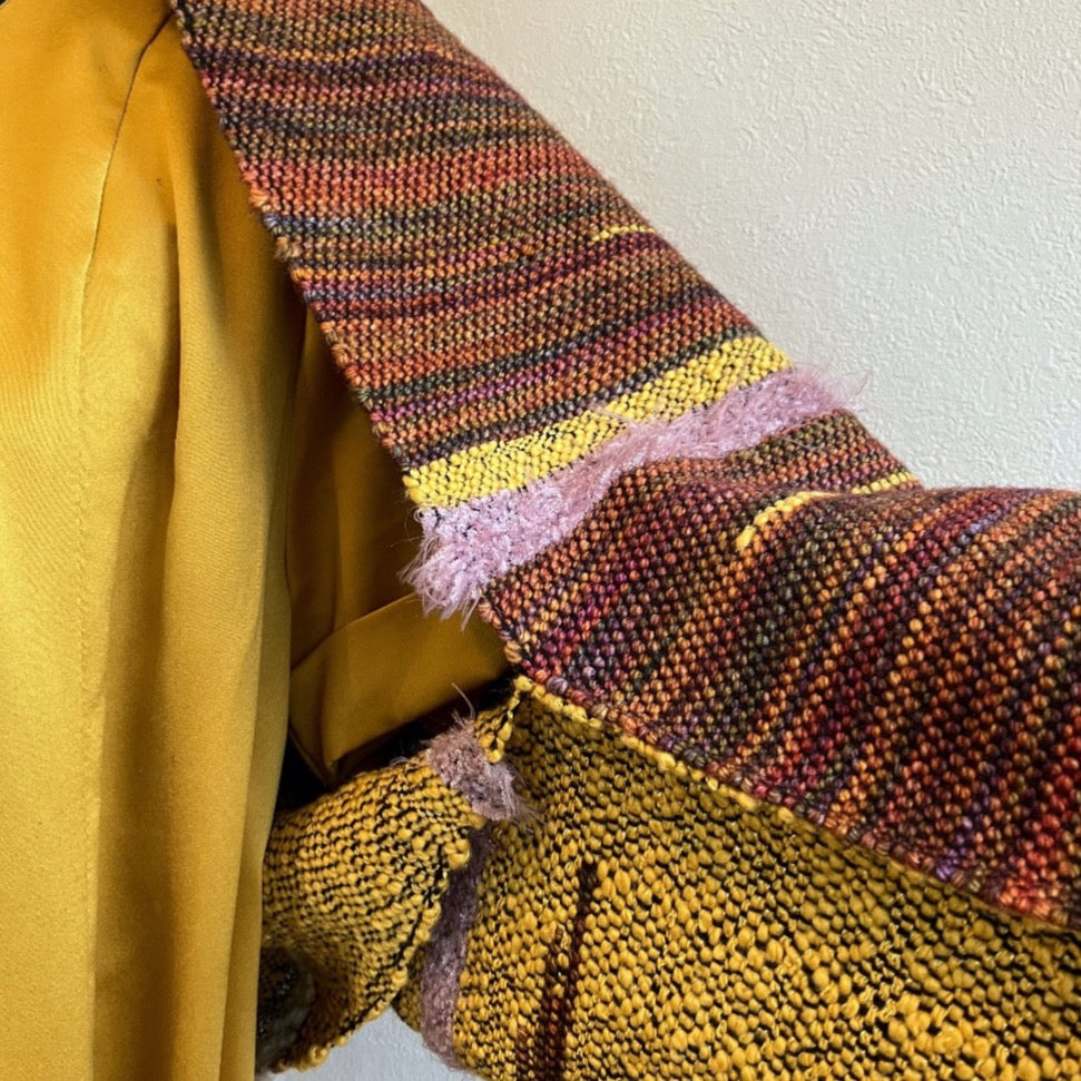 Detail of sleeve of brown and yellow shrug